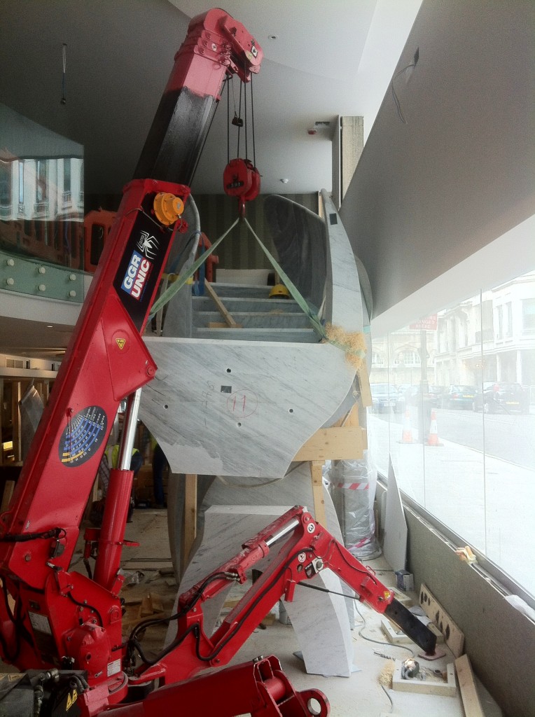 Unic 295 mini spider crane lifting marble at St James Theatre