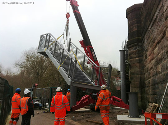 UNIC mini crane lifting staircase at Chester railway bridge