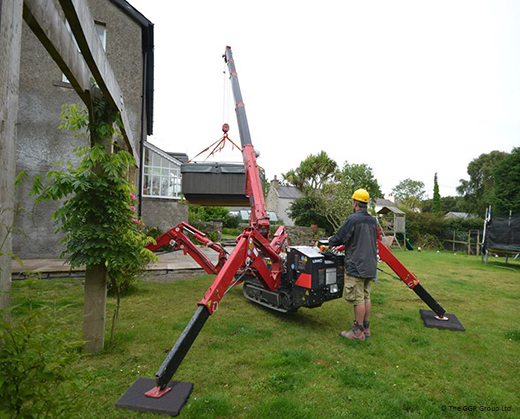 UNIC mini crane lifting hot tub