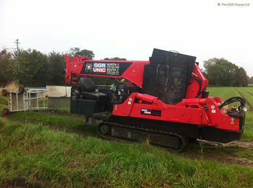 UNIC spider crane being tracked across farmers field