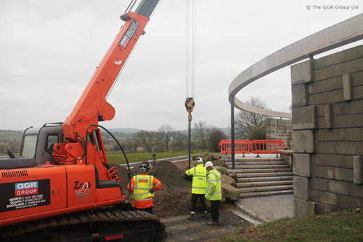 Mini crawler crane lifting boulders