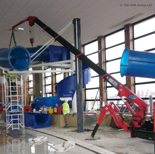 UNIC mini crane installing swimming pool slide