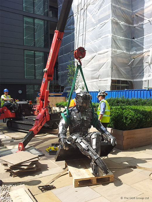 UNIC mini crane lifts steel statue