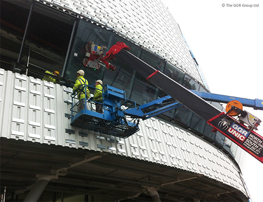 UNIC crane and GL-UMC600 install angled glazing at velodrome