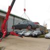 UNIC URW-706 Mini Spider Crane using a car lifting hoist to lift a car.