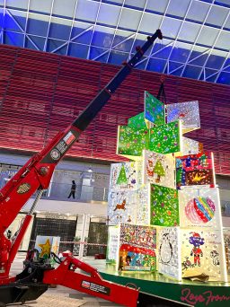 UNIC URW-546 Mini Spider Crane lifting sections of a Christmas tree inside a shopping centre.