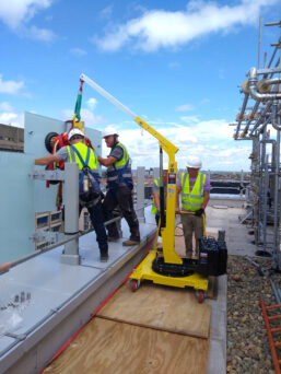 The Slewboy Floor Crane installing glass balustrades from a height.