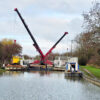 Two URW-706 Mini Spider Cranes lifting canal lock gates.